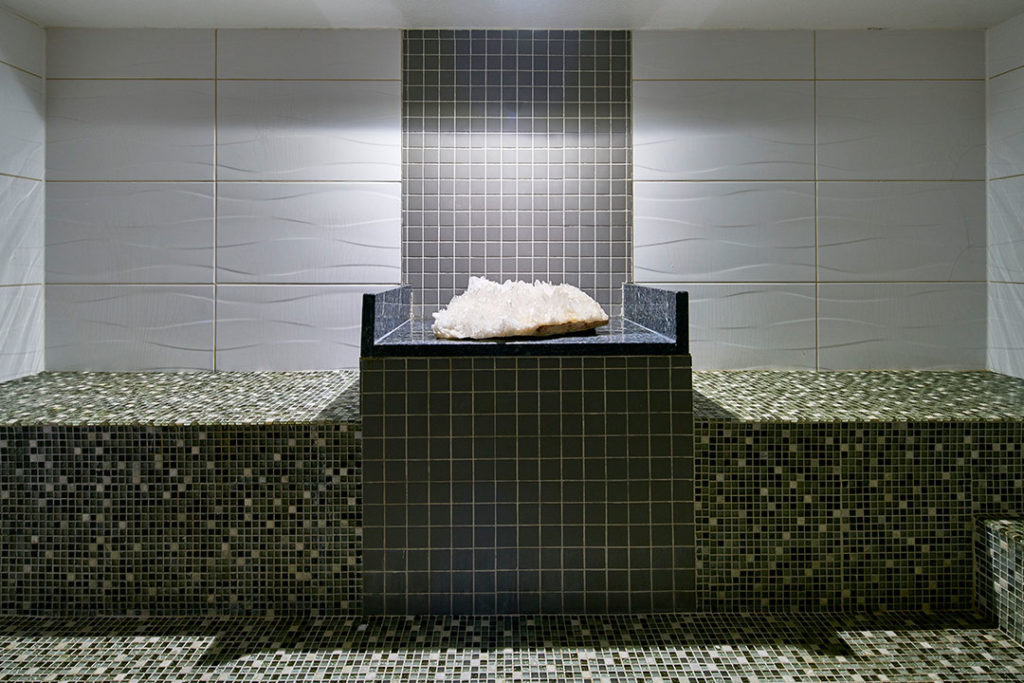 a heated crystal therapy room with a large crystal on a pedestal