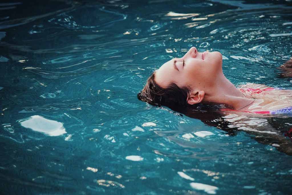 a woman floating in a pool
