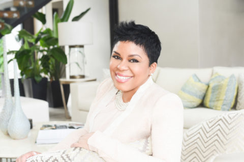 Woman sitting in living room head shot