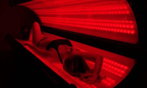 woman laying down in red light therapy