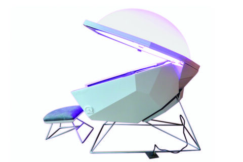 white pod with the lid open and a ottoman