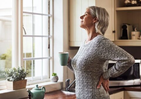 Woman breathing in fresh air as she enjoys her cup of coffee