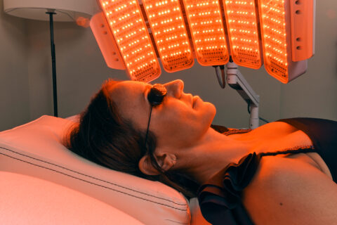 Red light on a womans face for antiaging