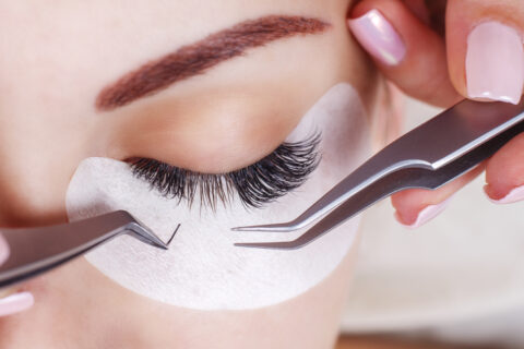 Female getting eyelash extensions