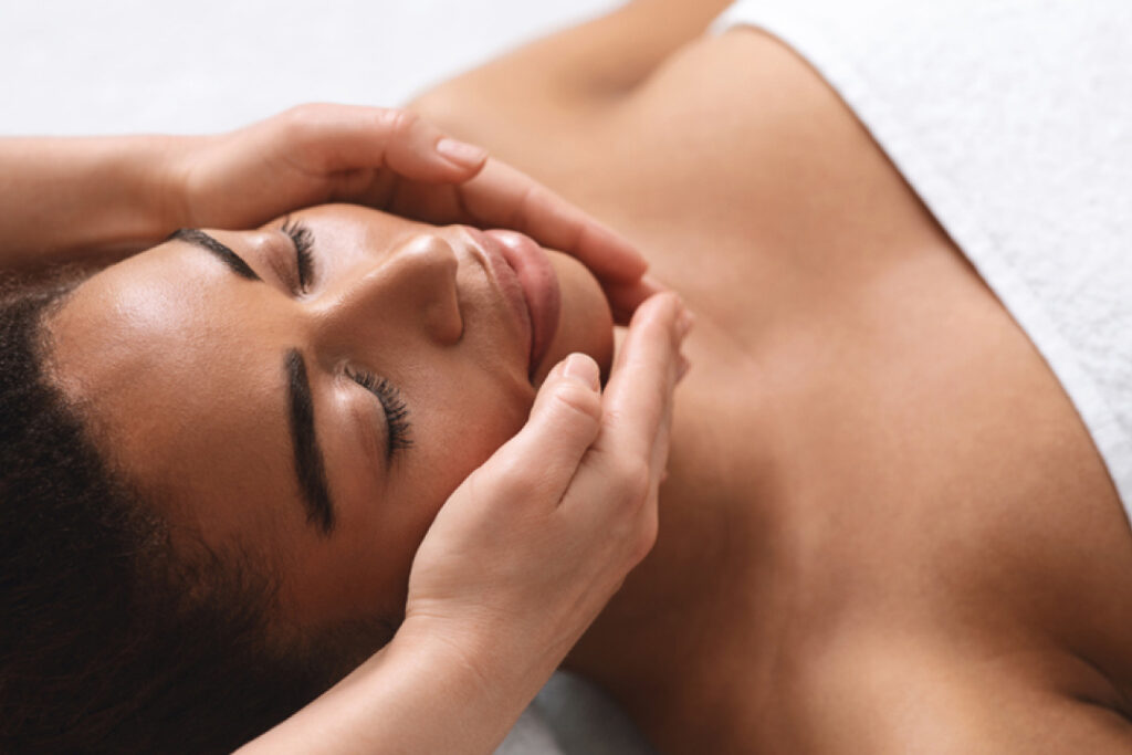 a woman receiving a facial massage