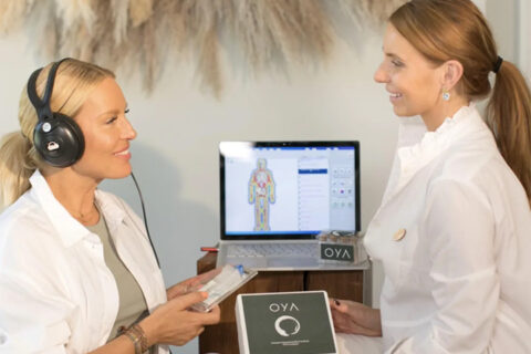 two women during consultation one with headphones and both wearing white